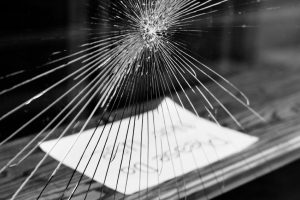 Shattered glass, shop window. A message "Please do not use" is visible, out of focus.